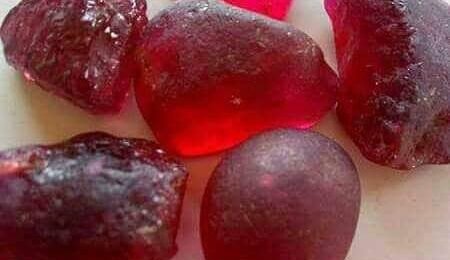 This stunning ruby is a testament to Nigeria's rich gemstone heritage. A vibrant ruby gemstone, showcasing its deep red color and natural beauty.