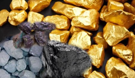 Close-up image of shiny gold nuggets on a dark surface, symbolizing the abundant gold reserves and investment potential in Nigeria's burgeoning gold mining sector.