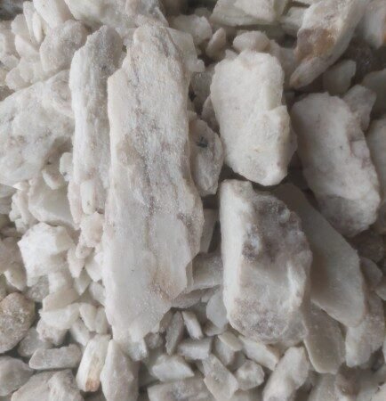 This is Nigerian mined lithium ore, a crucial component in the production of batteries for electric vehicles and other clean energy technologies. A close-up macro photograph of a raw, rough-hewn Nigerian mined lithium ore.