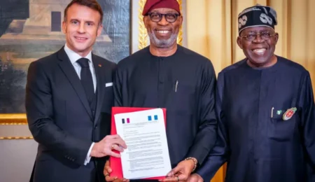 Nigeria and France forge a new path towards prosperity and sustainability. The signing of this mining agreement marks a significant milestone for both nations. President of Nigeria, President of France, and Nigerian Minister of Solid Mineral Development shaking hands to commemorate the signing of a mining agreement.