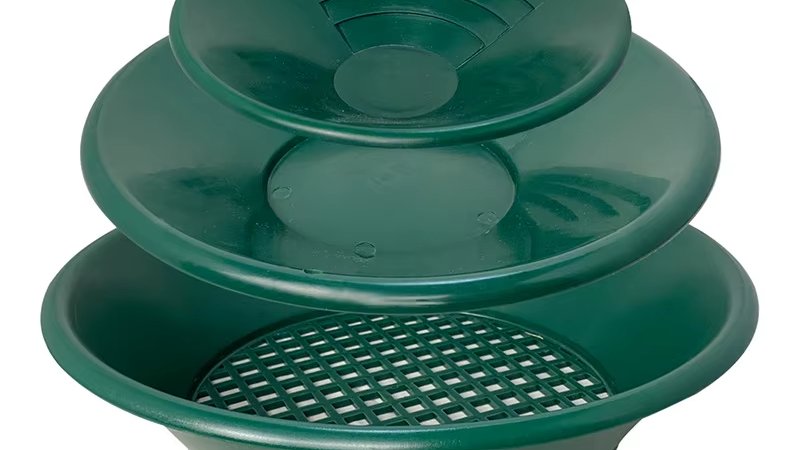 Get started with gold exploration in Nigeria! Our lightweight and affordable panning kit has all the essentials. A beginner's gold panning kit containing a green pan, snuffer bottle, tweezers, magnifying glass, and sample vials.