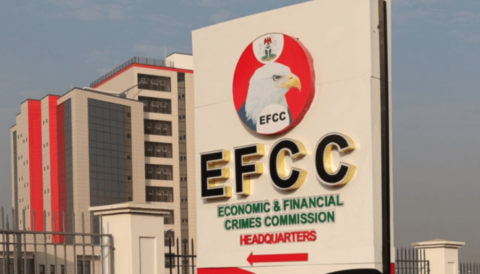 The Economic and Financial Crimes Commission (EFCC) presents a symbolic cheque of ₦100 million to the Ministry of Solid Minerals Development. The recovered funds, seized from mining companies, are part of a major anti-corruption push in the sector. Official signpost of the Economic and Financial Crimes Commission (EFCC) in Abuja, Nigeria.