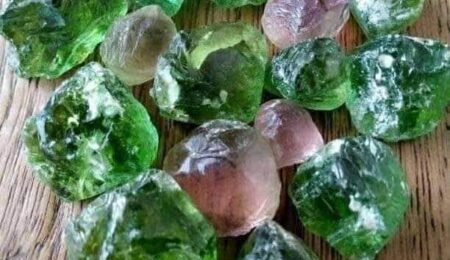 A stunning example of the colorful tourmaline found within Nigeria's rich gemstone deposits. Explore the state-by-state guide to discover more about Nigeria's gem locations. Vibrant bi-color (green and pink) Nigerian tourmaline crystal from a deposit in Nigeria, showcasing the country's gemstone wealth.