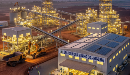 An aerial view of a modern mining operation in Nigeria at sunrise, showing heavy machinery, a processing plant, and a workforce.